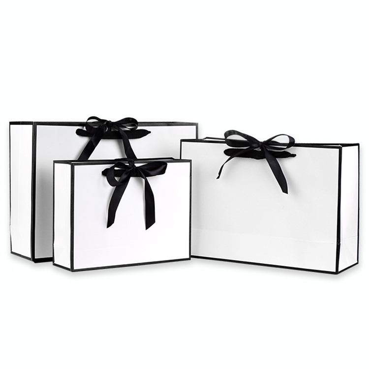 white paper bags with string handles
